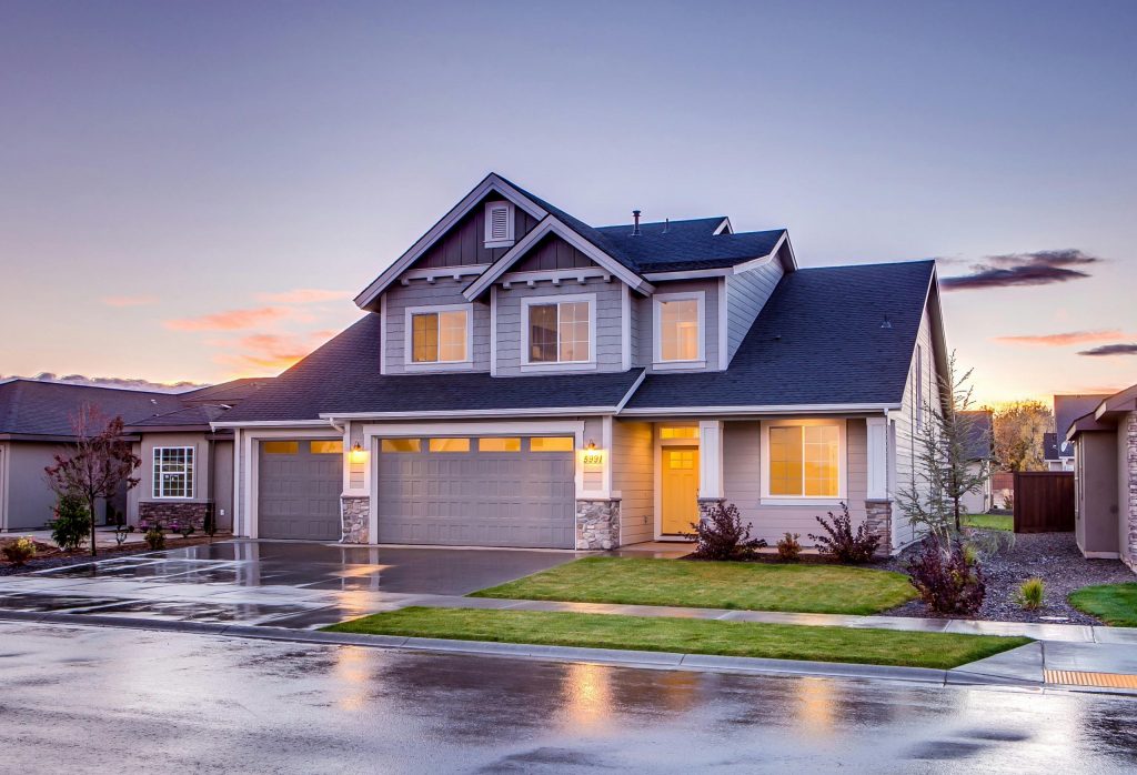 Blue and gray concrete house with attic during twilight